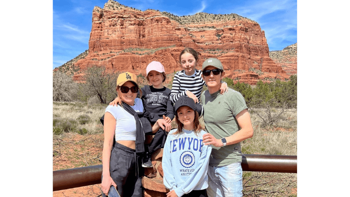 Family posed in front of large rock mesa in the American Southwest