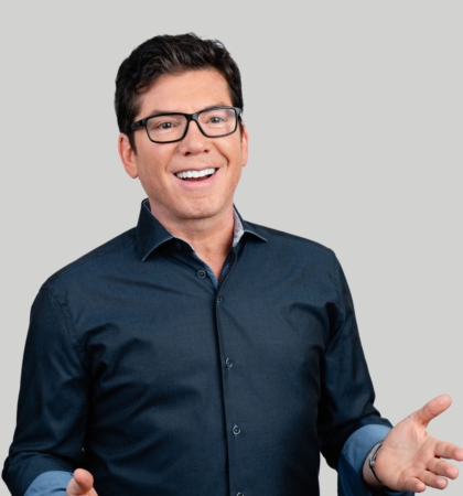 headshot of man in blue shirt