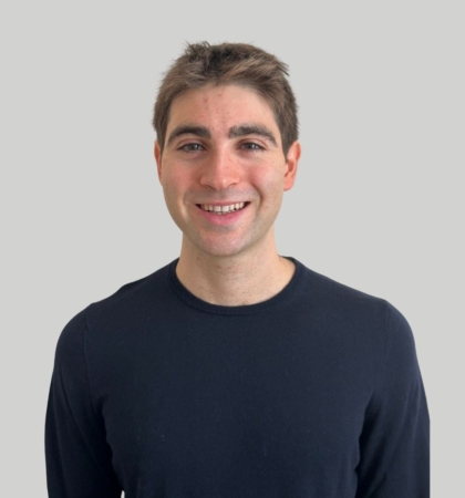 headshot of man on gray background