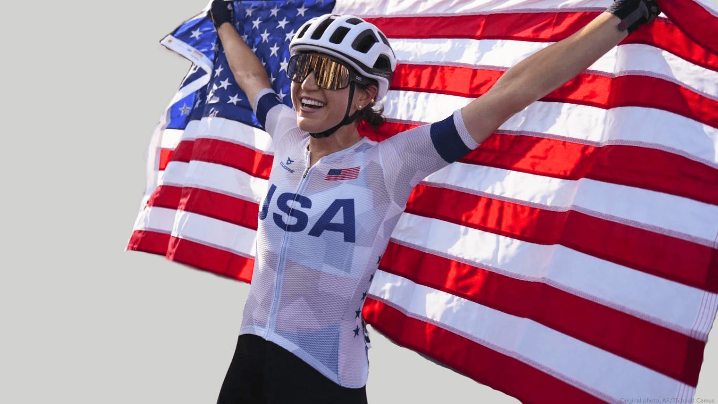 photo of female team usa cyclist holding american flag