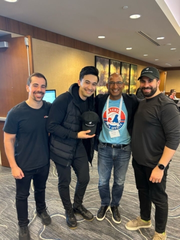 Group photo of four men in an office