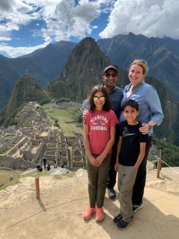 Family standing at a vista point of Machu Pichu