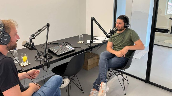 Two men having conversation with headphones and microphones