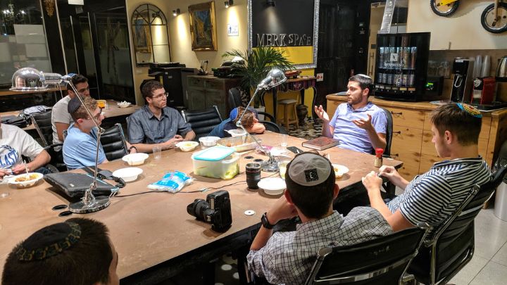 men around table having a discussion