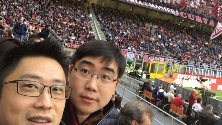 photo of two men inside crowded sports stadium