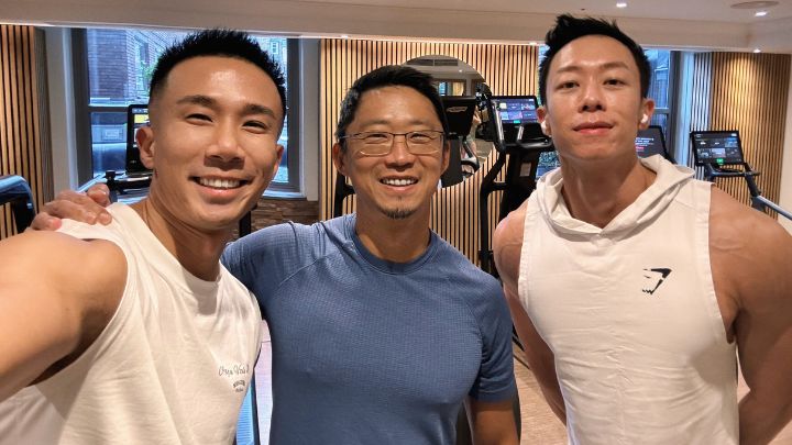 Posed group photo of three men at gym