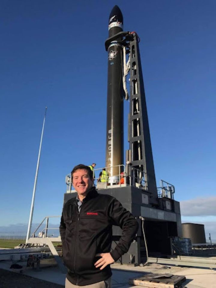 Man standing in front of rocket ship