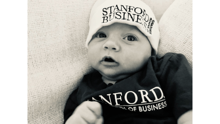 baby in Stanford Graduate School of Business onesie and hat