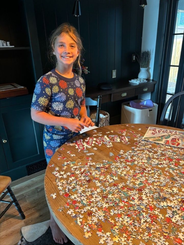 girl doing a puzzle at the table