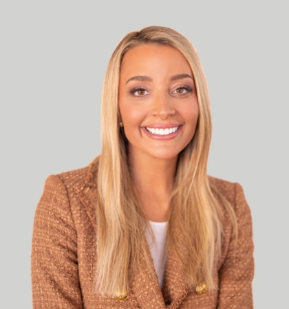 headshot of woman in brown blazer